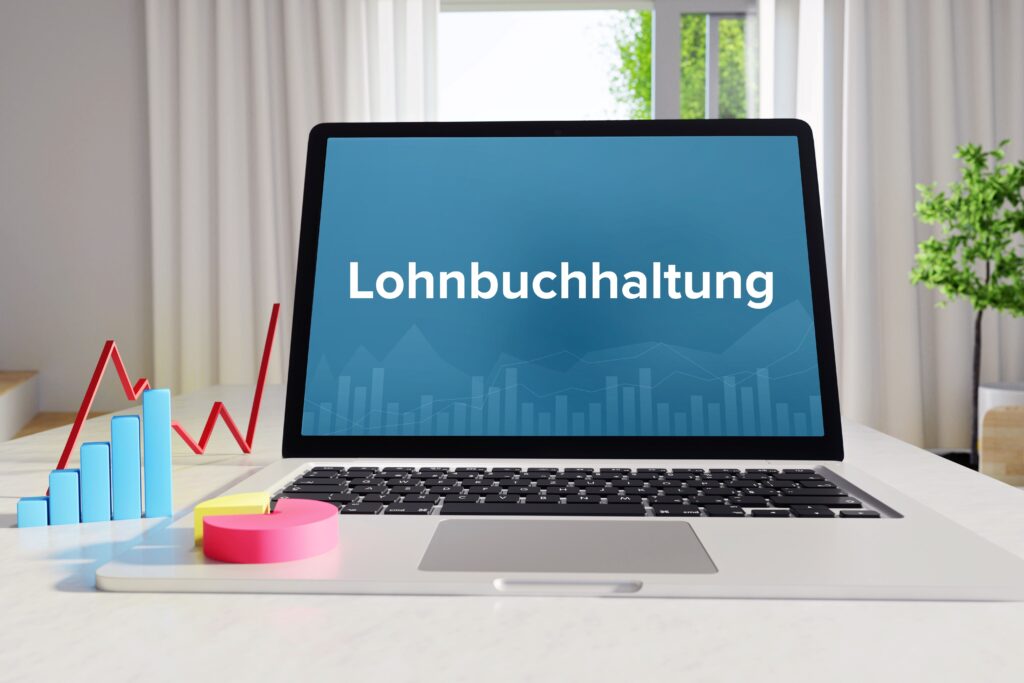 Ein Laptop auf dem Lohnbuchhaltung steht